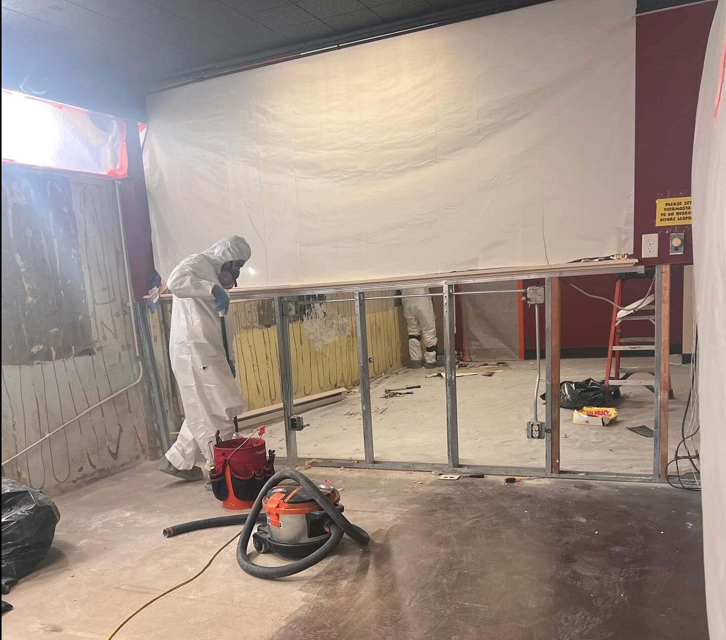 Commercial space stripped to the studs inside plastic containment