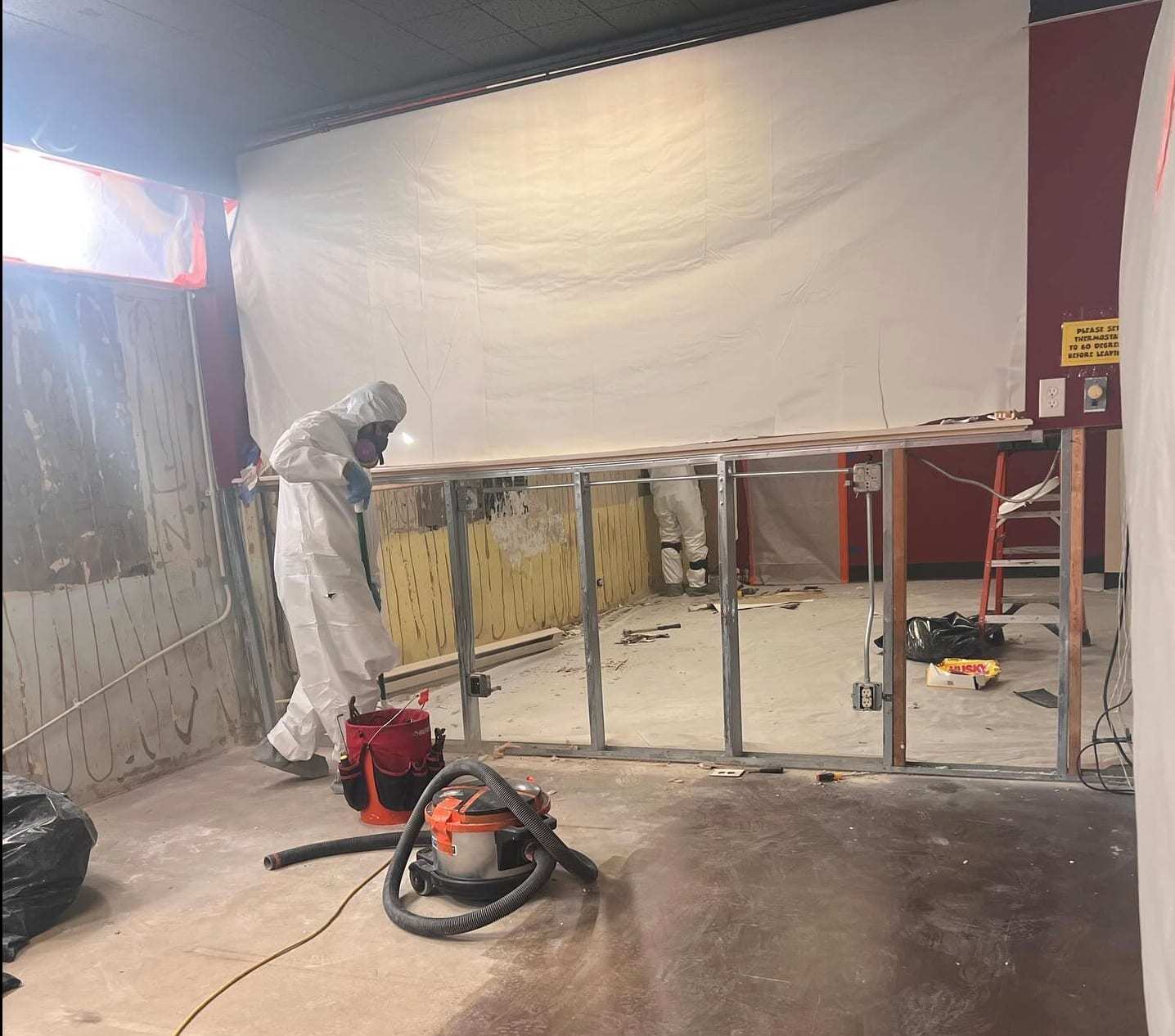 Commercial space stripped to the studs inside plastic containment